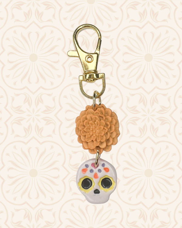 611fc05e3c4ce80992caae23_sugar-skull-marigold-bag-charm_1790634580516.png
